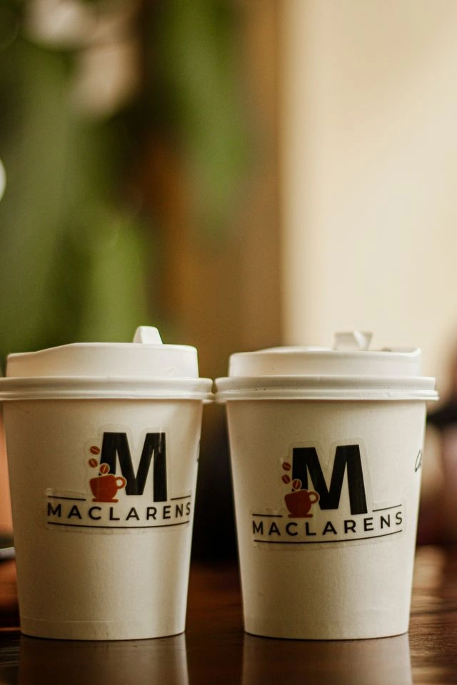 Coffee cups and jars wearing printed labels